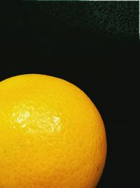 Close-up of yellow fruit against black background