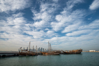 Sailboats in sea against sky