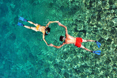 High angle view of people swimming in sea