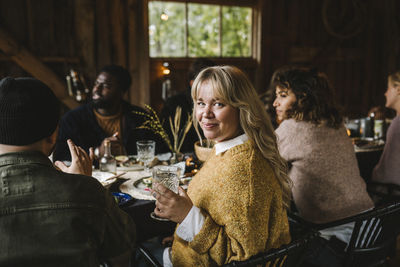 Portrait of friends sitting on table