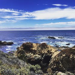 Scenic view of sea against cloudy sky