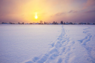 A beautiful winter morning landscapes with human feet tracks in snow.