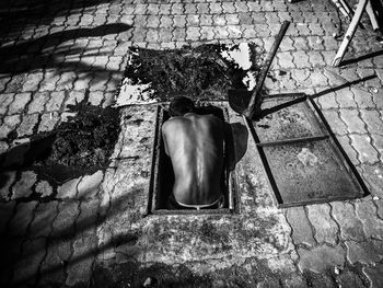 A man cleaning dirty gutter