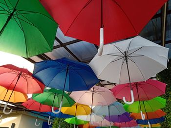 Low angle view of multi colored umbrellas hanging