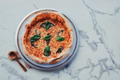 High angle view of pizza served on table