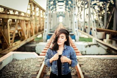 Young woman using smart phone while standing outdoors