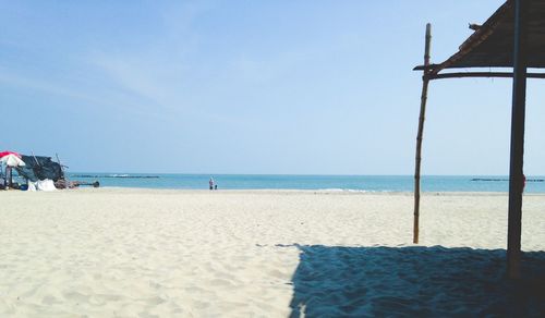 Scenic view of beach against blue sky