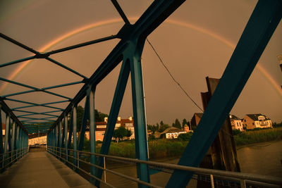 Bridge over river in city against sky