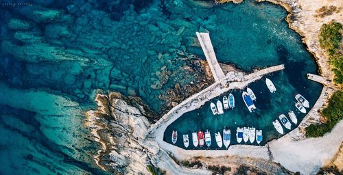 High angle view of boats moored at harbor