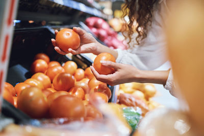 Midsection of woman holding tomatoes