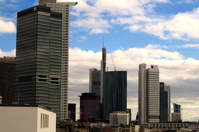 View of skyscrapers against cloudy sky