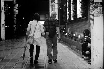 Rear view of man standing in city