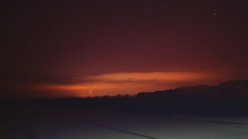 Scenic view of silhouette landscape against sky at sunset