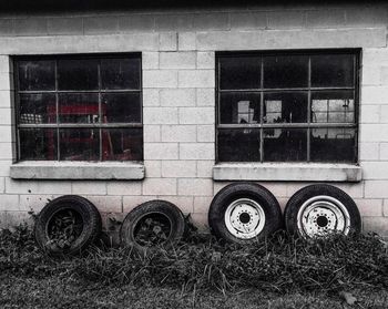 Close-up of tire on grass against building