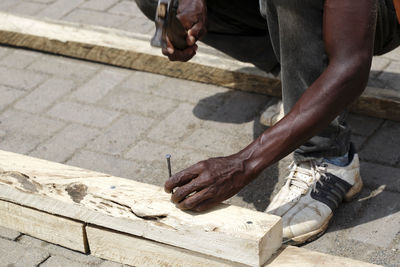 Low section of man working at workshop