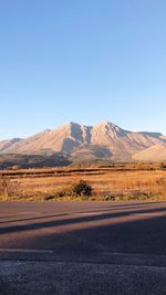 Scenic view of mountains against clear blue sky