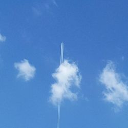 Low angle view of vapor trails in sky