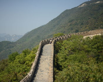 Person at great wall of china by mountain
