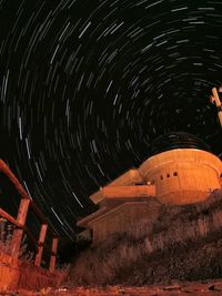 Low angle view of illuminated lighting equipment at night