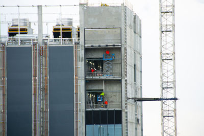 People working at construction site in city