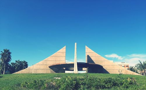 Low angle view of building against clear blue sky