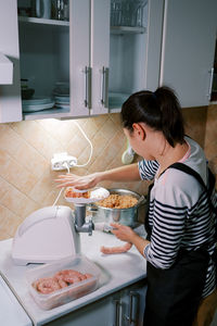 High angle view of mother and daughter in kitchen