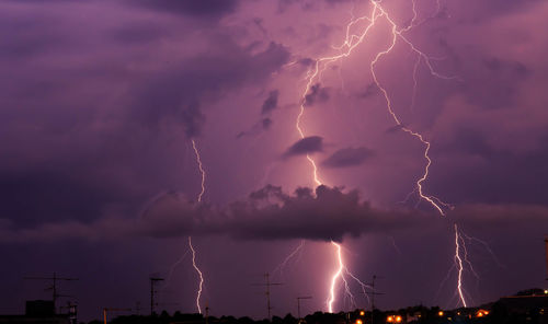 Lightning in the clouds in the city in the night sky
