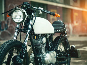 Close-up of motorcycle on footpath