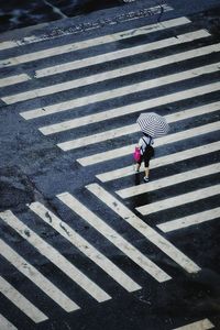High angle view of people crossing road