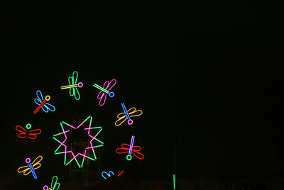 Illuminated christmas lights against black background