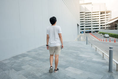 Full length rear view of man walking in building