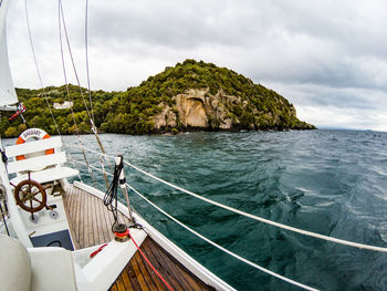 Sailboat sailing in sea against sky