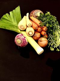 High angle view of vegetables on table against black background
