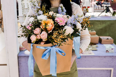 Woman - florist holding a bouquet in her hands