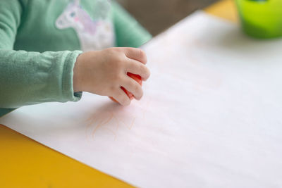 High angle view of baby hand on table