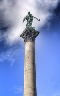 Low angle view of sculpture against blue sky