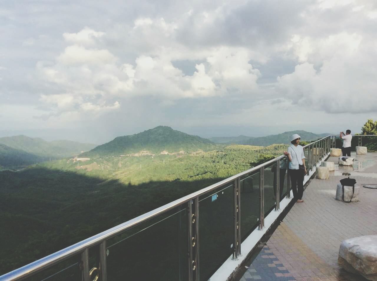 mountain, sky, cloud - sky, railing, mountain range, cloudy, scenics, cloud, nature, tranquil scene, tranquility, beauty in nature, water, leisure activity, lifestyles, landscape, built structure, men, day