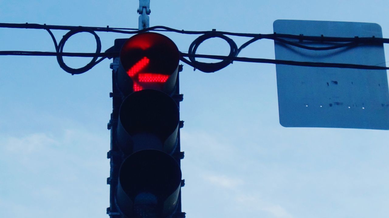 LOW ANGLE VIEW OF STOP SIGN AGAINST SKY