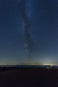 Scenic view of landscape against sky at night