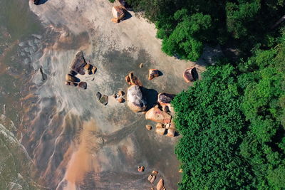 High angle view of people on rocks by lake