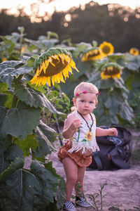 Full length of girl with yellow flowers