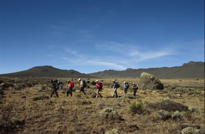 People on landscape against sky