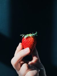 Cropped image of person holding spoon over white background