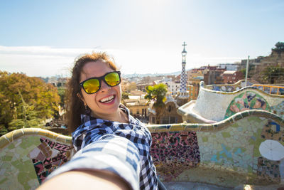 Portrait of smiling young woman wearing sunglasses