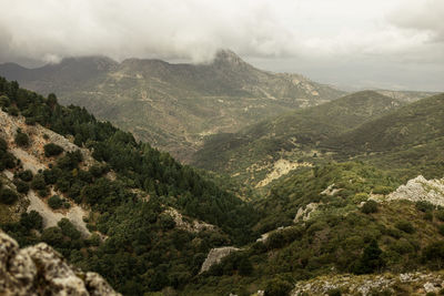 Scenic view of valley and mountains against sky