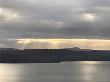 Scenic view of sea and mountains against sky