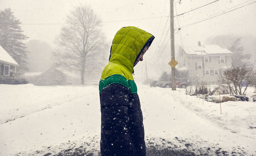 Full length of child on snow covered road during winter