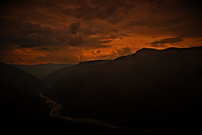 Scenic view of silhouette mountain against sky at sunset