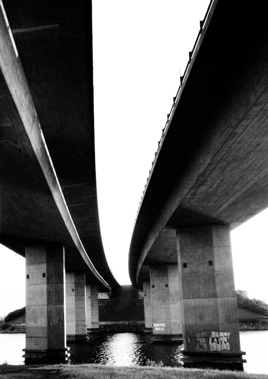 architecture, built structure, connection, bridge - man made structure, engineering, bridge, water, waterfront, river, transportation, low angle view, clear sky, architectural column, long, support, building exterior, column, sky, suspension bridge, outdoors