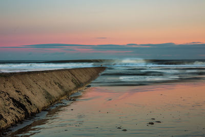 Scenic view of sea against sky at sunset